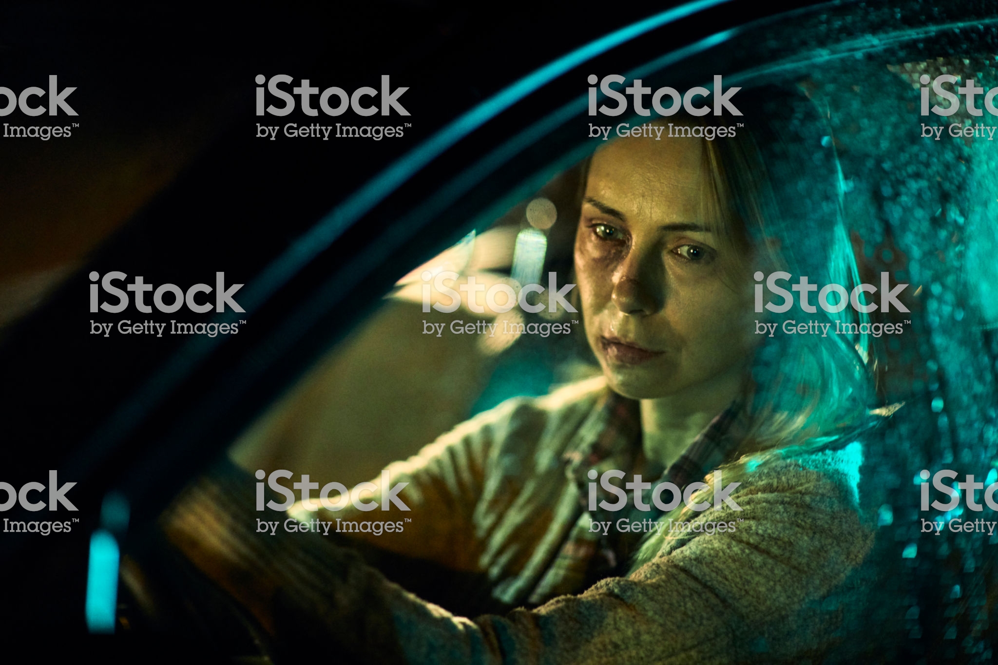 Close up of a injured and scared woman driving a car